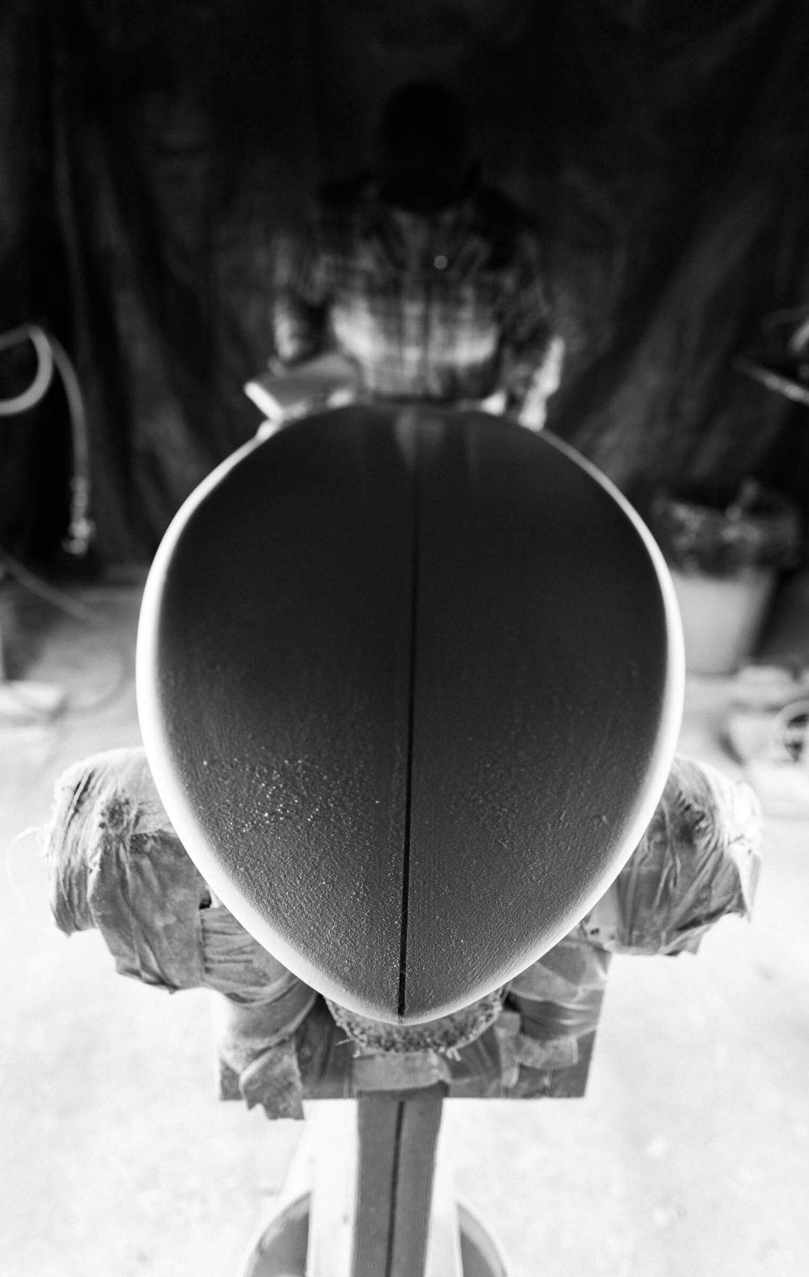 Hand-shaping a surfboard at Lazy Robot