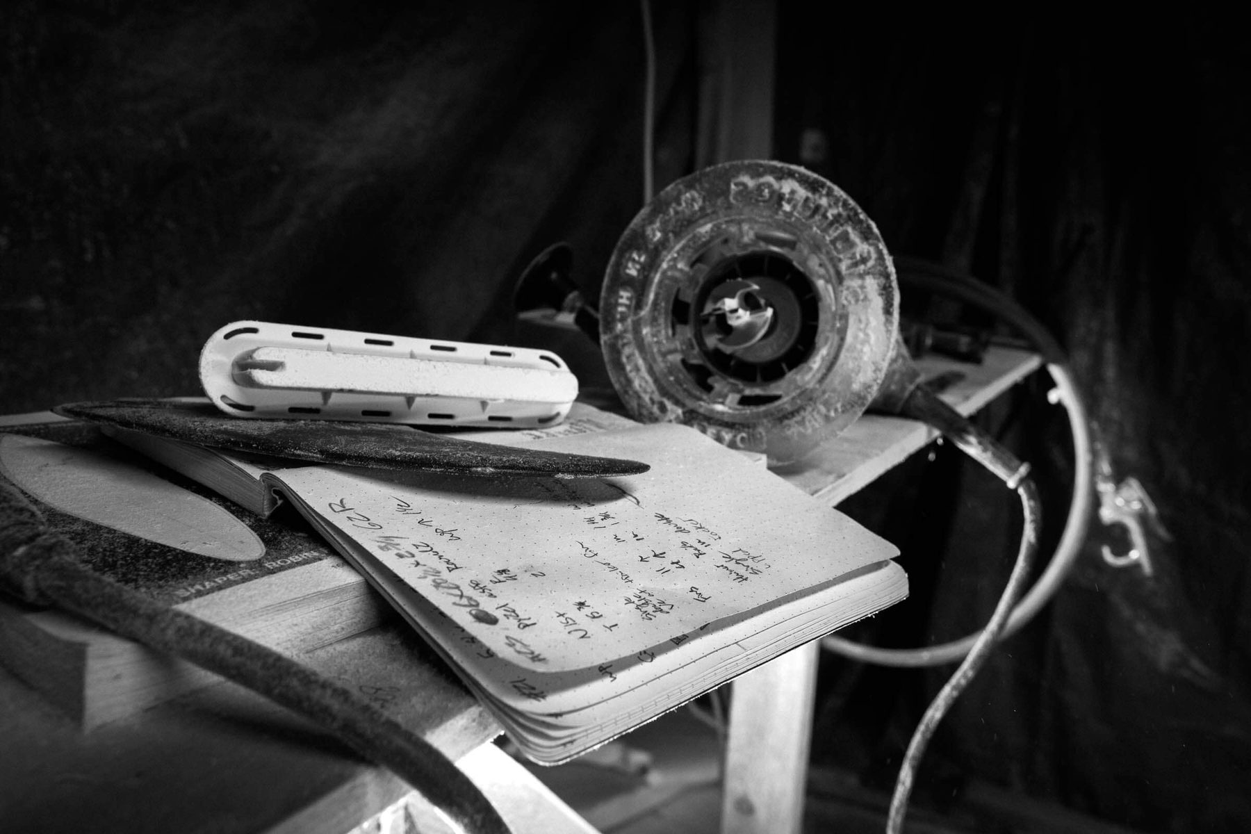 Hand-shaping a surfboard at Lazy Robot