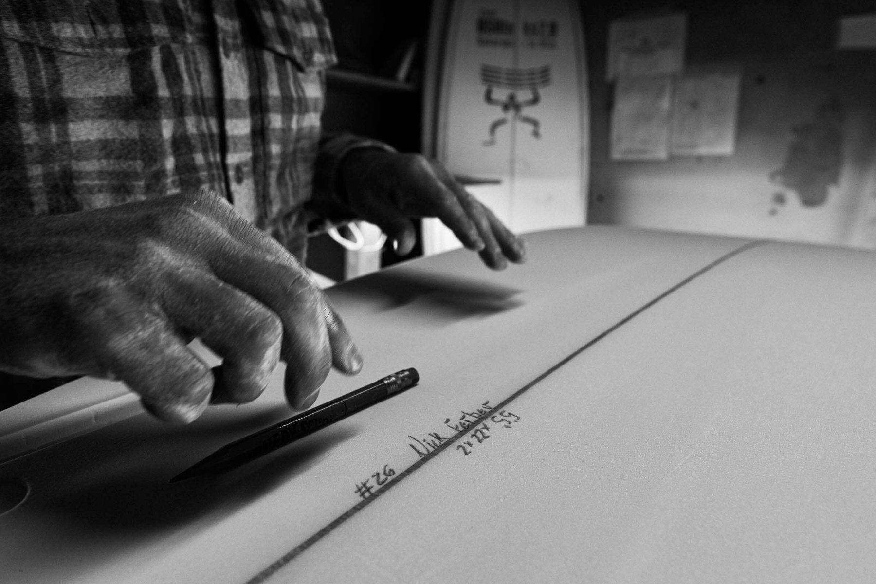 Hand-shaping a surfboard at Lazy Robot