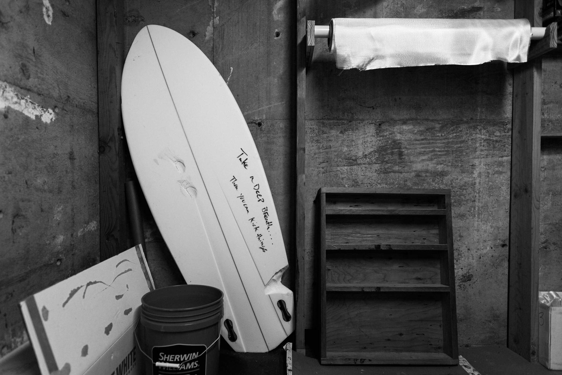 Hand-shaping a surfboard at Lazy Robot