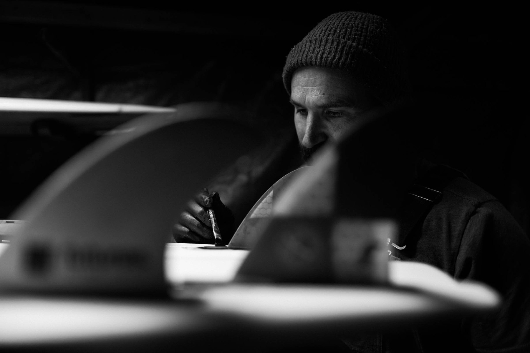 Hand-shaping a surfboard at Lazy Robot